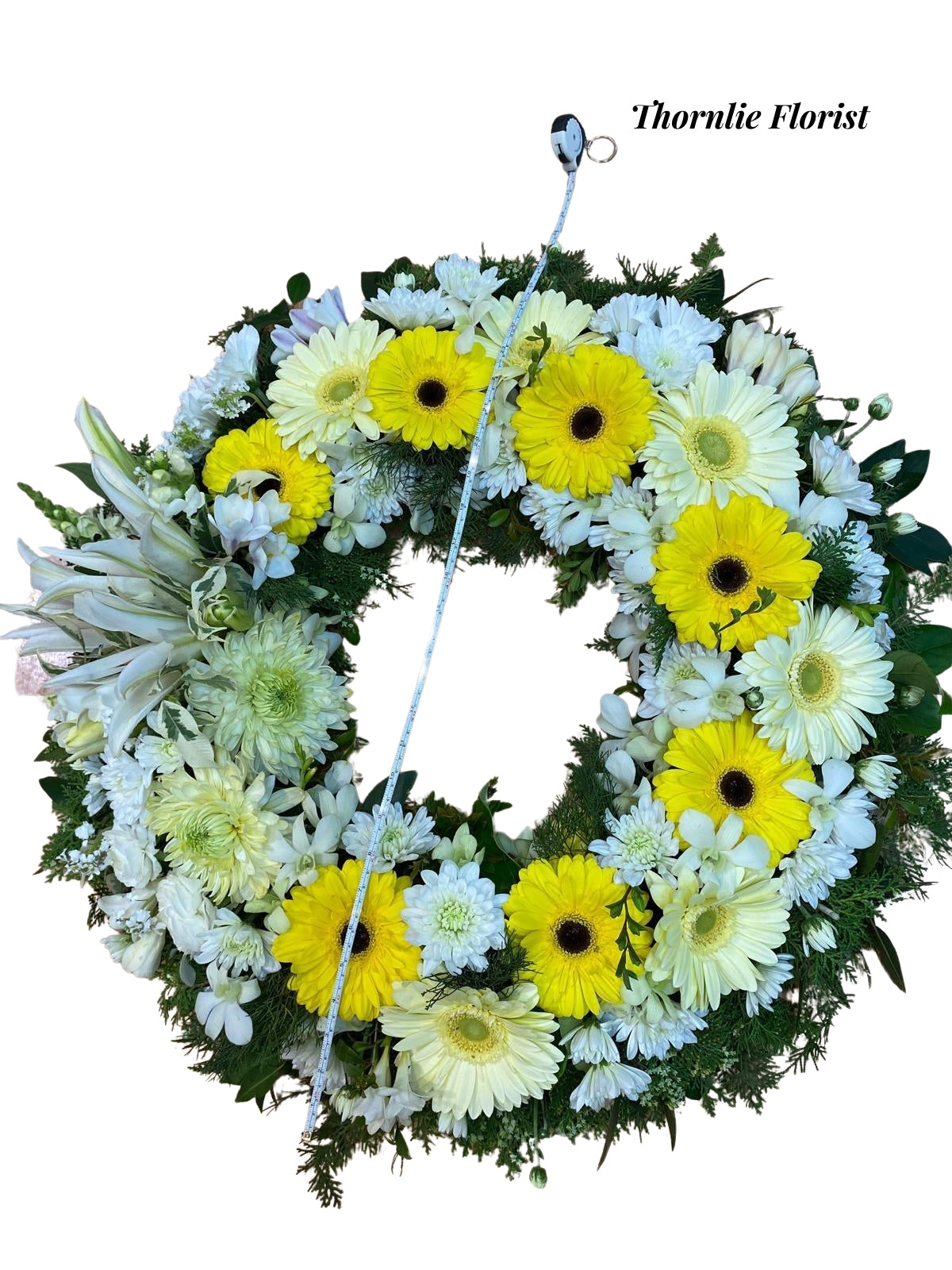 Funeral wreath with yellow gerbera daisies and white lilies by Thornlie Florist.