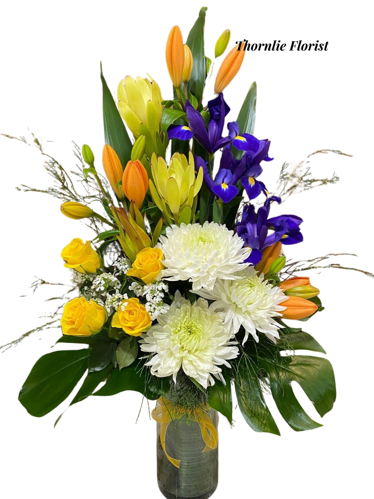 Sunset Serenade Vase featuring yellow roses, white chrysanthemums, and purple irises.