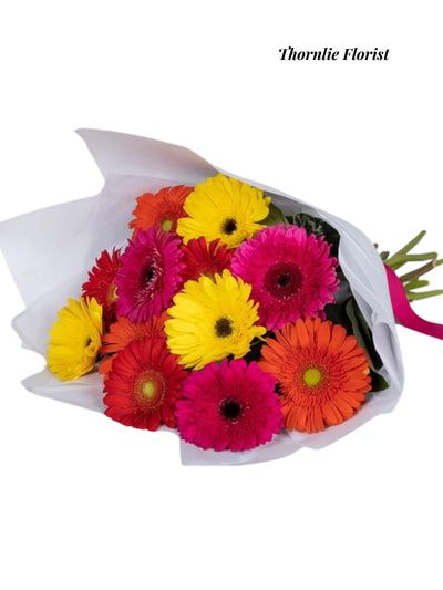 Rainbow Radiance Gerbera Bouquet with colorful yellow, pink, orange, and red flowers.