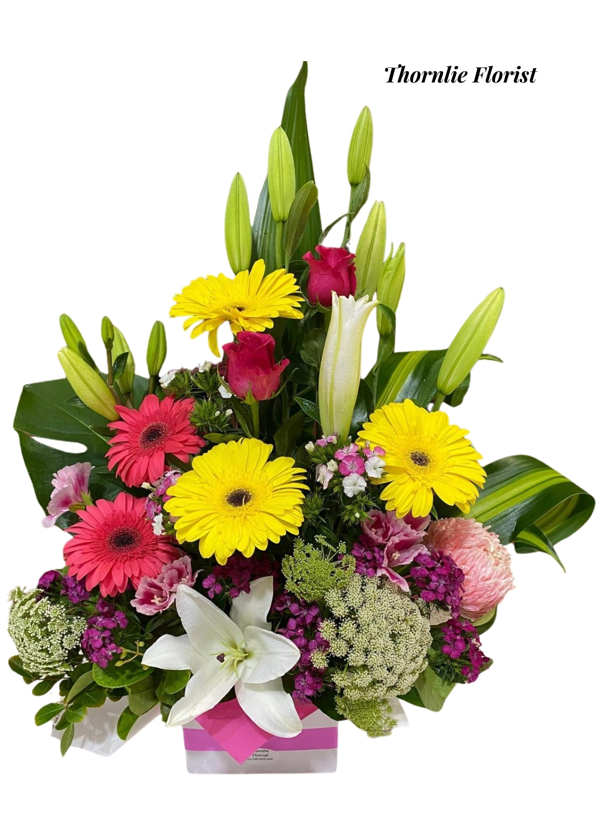 Colorful Delight arrangement featuring yellow gerberas, pink roses, and white lilies.