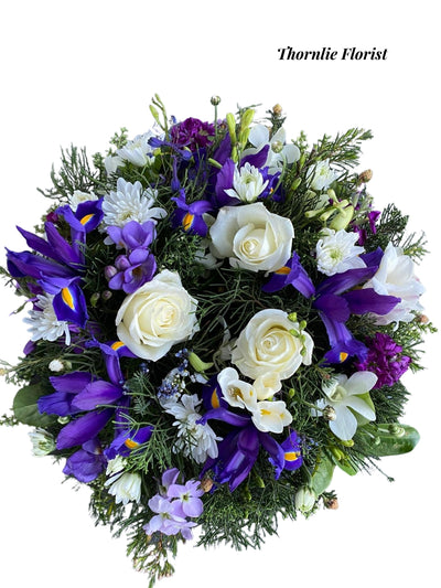 Serene Blue & White floral arrangement with white roses and purple irises by Thornlie Florist.