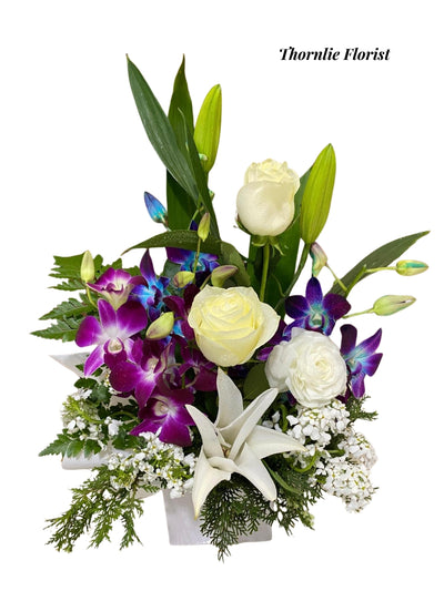 Graceful Blooms floral box featuring white roses and purple orchids by Thornlie Florist