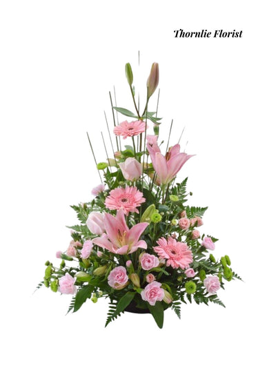 Pink sympathy flower arrangement with lilies and gerbera daisies by Thornlie Florist.