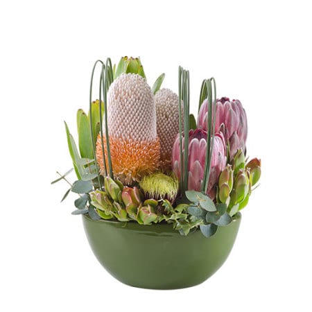 Kirra Bouquet by Thornlie Flourist featuring pink proteas and white banksia in a green bowl.